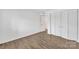 Bright bedroom featuring wood-look flooring and ample closet space at 1323 Queens Rd # 312, Charlotte, NC 28207