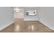 Bright living room with light wood floors and view to the kitchen at 1323 Queens Rd # 312, Charlotte, NC 28207