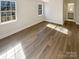 Large bedroom with wood-look floors and bright natural light at 13943 Dannemara Dr, Pineville, NC 28134