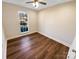 Bright bedroom featuring wood-look floors and a large window at 13943 Dannemara Dr, Pineville, NC 28134