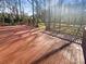 Large deck overlooks a wooded backyard, ideal for relaxing at 13943 Dannemara Dr, Pineville, NC 28134