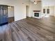 Open living area with hardwood floors and fireplace at 13943 Dannemara Dr, Pineville, NC 28134