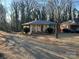 Brick ranch home with covered porch and landscaped yard at 1401 Chelveston Dr, Charlotte, NC 28208