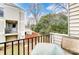 Small balcony with a table and chairs, offering a view of the backyard at 1605 Merry Oaks Rd # E, Charlotte, NC 28205