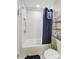 Clean bathroom with shower/tub combo and white tile at 1605 Merry Oaks Rd # E, Charlotte, NC 28205