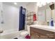 Clean bathroom with white tiled walls, a tub shower combo, and a modern vanity at 1605 Merry Oaks Rd # E, Charlotte, NC 28205