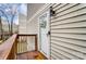 Unit entryway with private deck features a white door with decorative window and black lantern fixture at 1605 Merry Oaks Rd # E, Charlotte, NC 28205