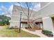 Apartment building exterior with wooden staircases leading to unit entrances on each floor at 1605 Merry Oaks Rd # E, Charlotte, NC 28205