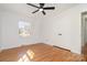 Clean bedroom featuring hardwood floors, a ceiling fan, and a closet at 2100 Knickerbocker Dr, Charlotte, NC 28212