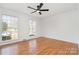 Spacious bedroom showcasing hardwood floors, large windows, and a modern ceiling fan at 2100 Knickerbocker Dr, Charlotte, NC 28212