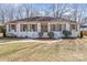 A welcoming home with a white brick facade, green wreaths on the front doors, and well-maintained landscaping at 2100 Knickerbocker Dr, Charlotte, NC 28212