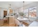 Bright kitchen with white cabinets, island seating, breakfast nook, and modern pendant lighting at 2100 Knickerbocker Dr, Charlotte, NC 28212