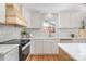 Modern kitchen features white subway tile, stylish range hood, and premium countertops at 2100 Knickerbocker Dr, Charlotte, NC 28212