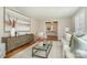 Bright living room with neutral tones, plush seating, a decorative rug, stylish cabinet, and plenty of natural light at 2100 Knickerbocker Dr, Charlotte, NC 28212