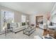 Bright living room with neutral tones, plush seating, a decorative rug and plenty of natural light at 2100 Knickerbocker Dr, Charlotte, NC 28212