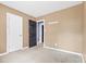 Bedroom with tan walls, closet, and door to another room at 2209 Donnabrook Ln, Gastonia, NC 28052