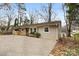 Ranch style home with gravel driveway and mature trees at 2209 Donnabrook Ln, Gastonia, NC 28052