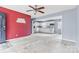 Living room with open concept to kitchen and red accent wall at 2209 Donnabrook Ln, Gastonia, NC 28052