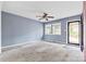 Spacious living room with carpeting, ceiling fan, and exterior access at 2209 Donnabrook Ln, Gastonia, NC 28052