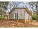 Home's rear features a door and brick foundation at 2209 Donnabrook Ln, Gastonia, NC 28052