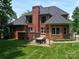 Backyard brick patio area with an outdoor dining set for entertaining at 252 Bay Shore Loop, Mooresville, NC 28117
