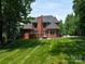 Expansive backyard featuring a well-maintained lawn and brick exterior at 252 Bay Shore Loop, Mooresville, NC 28117