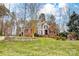 Charming brick home featuring a manicured lawn, mature landscaping, and stone accents at 252 Bay Shore Loop, Mooresville, NC 28117