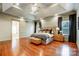 Bright main bedroom with hardwood floors, tray ceiling, and barn door to bathroom at 252 Bay Shore Loop, Mooresville, NC 28117