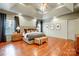 Spacious main bedroom with hardwood floors and tray ceiling, featuring a king-size bed at 252 Bay Shore Loop, Mooresville, NC 28117