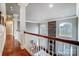 Elegant upper hallway with hardwood floors and white columns at 252 Bay Shore Loop, Mooresville, NC 28117