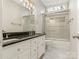 Bathroom with dark granite countertop, double vanity, and shower/tub combo at 2540 Ballencourt Ln, Charlotte, NC 28226