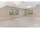 Large bedroom with neutral carpet and multiple windows at 2540 Ballencourt Ln, Charlotte, NC 28226