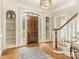 Bright and spacious entryway with hardwood floors and built-in shelving at 2540 Ballencourt Ln, Charlotte, NC 28226