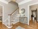 Elegant curved staircase with wooden railing in entryway at 2540 Ballencourt Ln, Charlotte, NC 28226