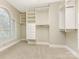 Spacious walk-in closet with custom shelving and drawers at 2540 Ballencourt Ln, Charlotte, NC 28226