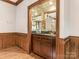 Built-in wet bar with mirrored backsplash and wood cabinetry at 2540 Ballencourt Ln, Charlotte, NC 28226