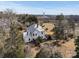 Aerial view of farmhouse, showcasing its size and setting at 2948 W Main St, Claremont, NC 28610