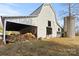 Classic white barn with covered area and hay bales, adjacent to a silo in a rural setting at 2948 W Main St, Claremont, NC 28610