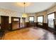 Bright dining room with hardwood floors, stained wood trim, and large windows at 2948 W Main St, Claremont, NC 28610