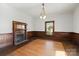 Formal dining room with hardwood floors, wood paneling, and chandelier at 2948 W Main St, Claremont, NC 28610