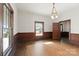 Dining room with hardwood floors, wood paneling, and large windows at 2948 W Main St, Claremont, NC 28610