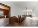 Long hallway with wood floors, wood paneling, and a staircase at 2948 W Main St, Claremont, NC 28610