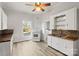 Kitchen features white cabinets, wood countertops, and hexagon tile backsplash at 2948 W Main St, Claremont, NC 28610