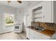 Cozy kitchen with white cabinets and hexagon backsplash at 2948 W Main St, Claremont, NC 28610