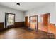 Living room with hardwood floors, wood walls, and a fireplace at 2948 W Main St, Claremont, NC 28610