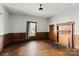 Living room with hardwood floors, wood paneling, and fireplace at 2948 W Main St, Claremont, NC 28610