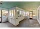 Large screened porch with whitewashed brick and wood floors at 2948 W Main St, Claremont, NC 28610