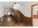 Wood staircase with wood railing in a long hallway at 2948 W Main St, Claremont, NC 28610