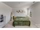 Spacious bedroom with large bed, green blanket, and gallery wall at 3021 Belstock Ct, Charlotte, NC 28216