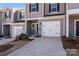 Townhome exterior with attached garage and landscaping at 3021 Belstock Ct, Charlotte, NC 28216